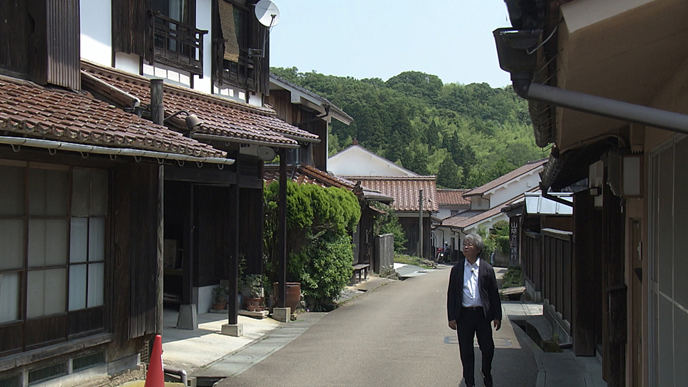 Fukasawa walks in the town.