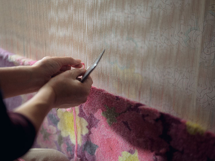 Producing a hand-woven Dantsu carpet Photo courtesy of Oriental Carpet Mills, Ltd..